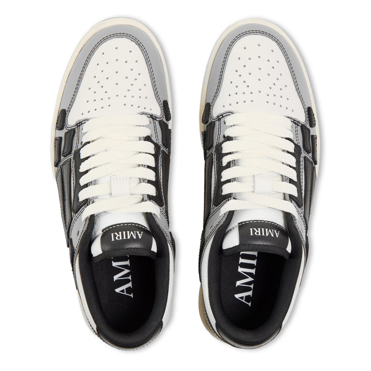 White-and-black low trainers with perforated toe and lace-up front