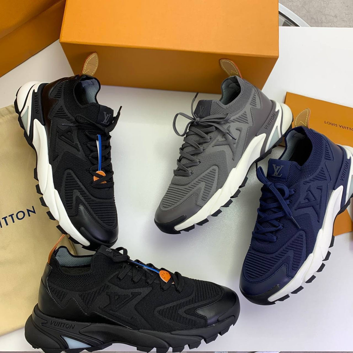 Trainer sneaker assortment with lace-up uppers in black, gray, and navy, chunky white soles