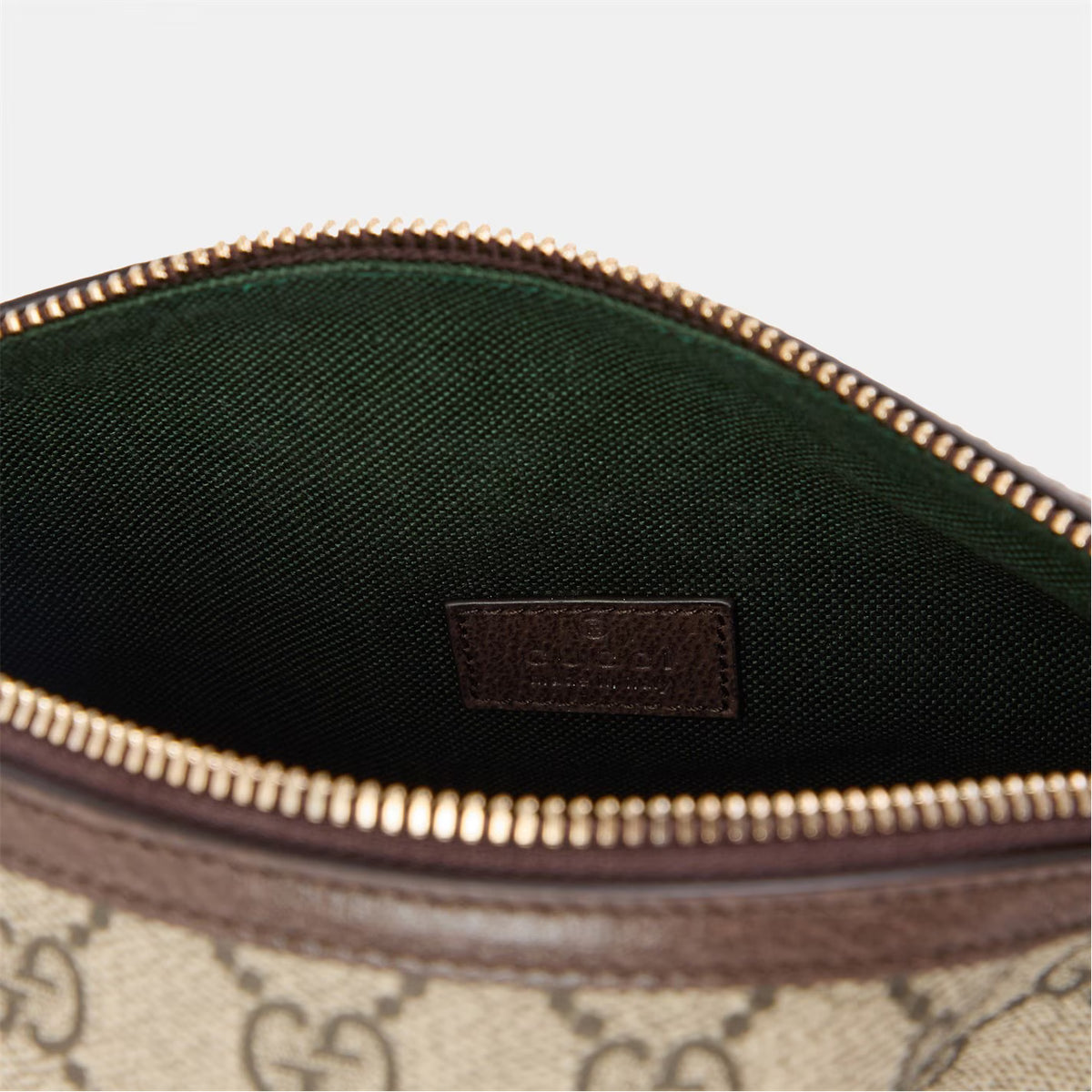 Mini hobo bag interior lining with leather brand patch and gold zipper trim