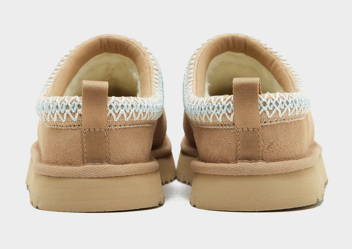 Back view of sand UG Tazz suede slippers with heel pull tab and light blue knit cuff