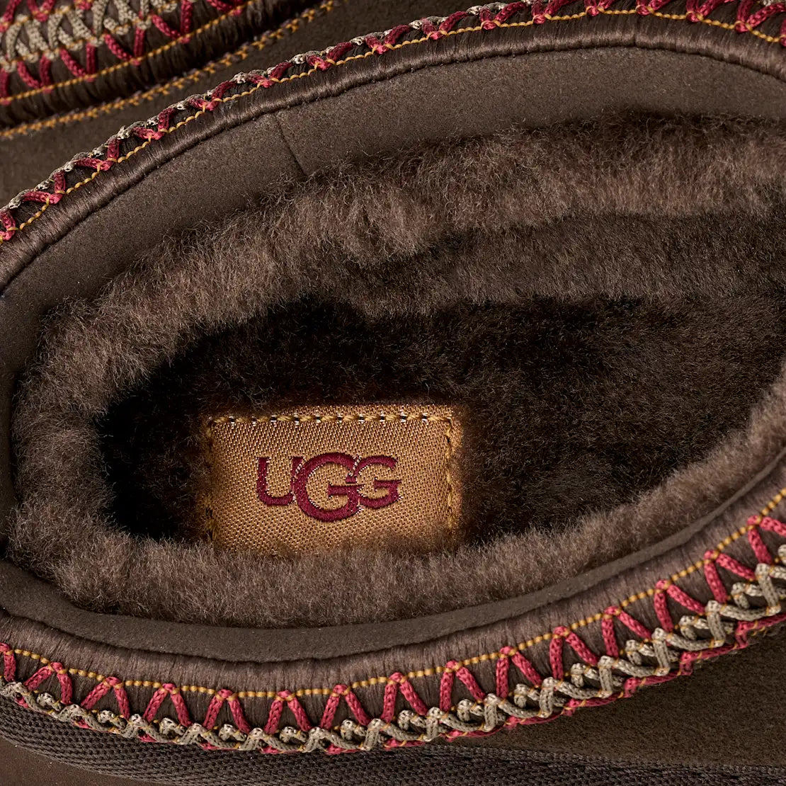 UG Dusted Cocoa interior view with UGG logo, faux-fur lining and red knit edge trim