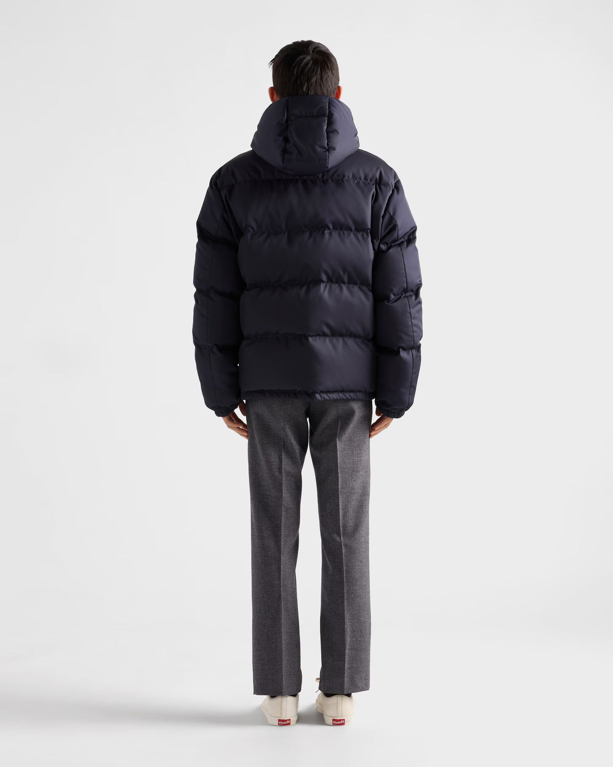 Back view hooded puffer jacket in dark navy, horizontal baffle quilting and hood.