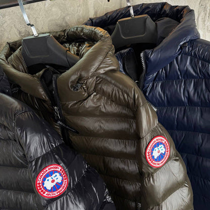 Puffy bubble jackets in olive and navy tones with round red logo patches