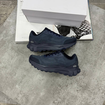Navy lace-up training shoes with mesh-like texture and thick rubber outsole