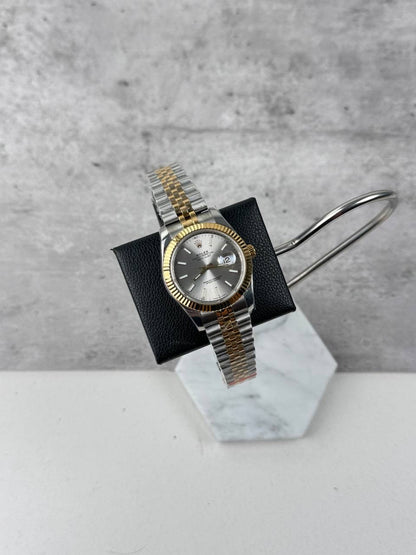 Rolex two-tone wristwatch with silver dial, fluted bezel, and metal bracelet