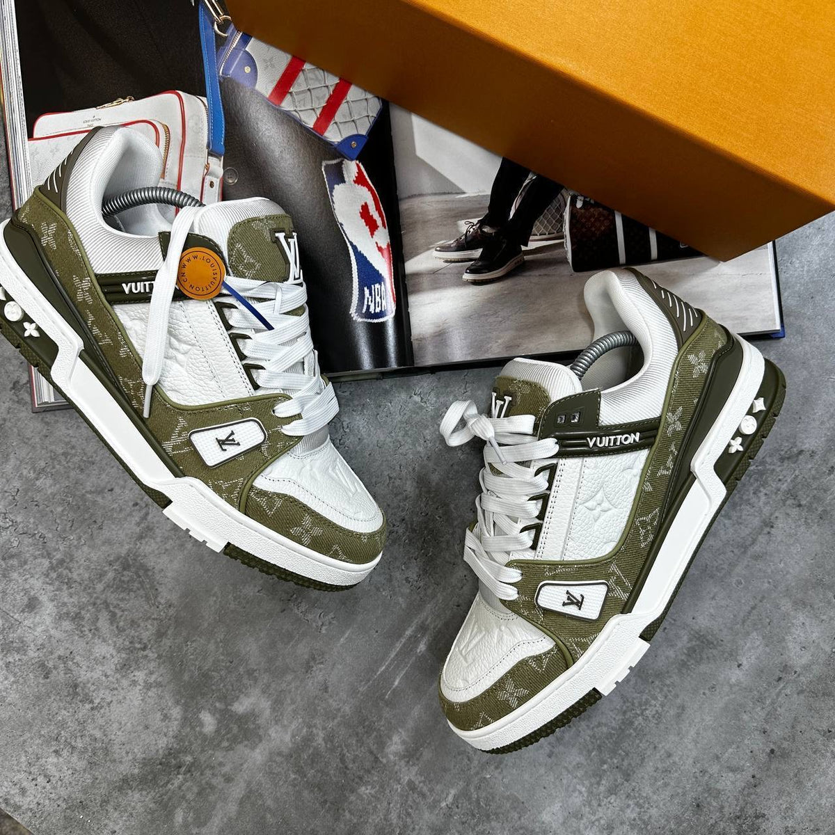Olive green and white LV lace-up trainers with side logo detailing and padded collar