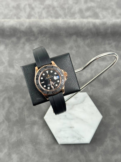 Rolex Yacht-Master style watch with black dial, rose-gold bezel, black strap
