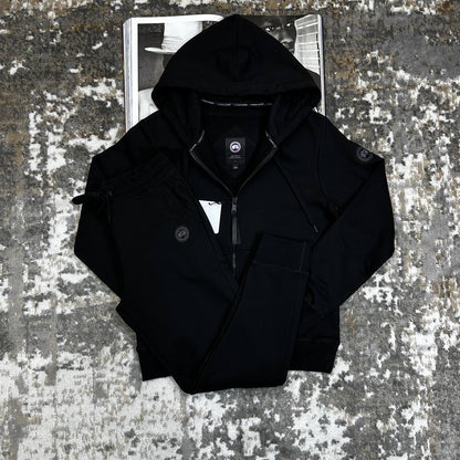 Black zip-up hooded tracksuit jacket with matching drawstring waist pants