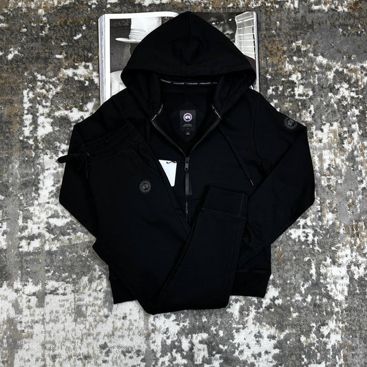Black zip-up hooded tracksuit jacket with matching drawstring waist pants