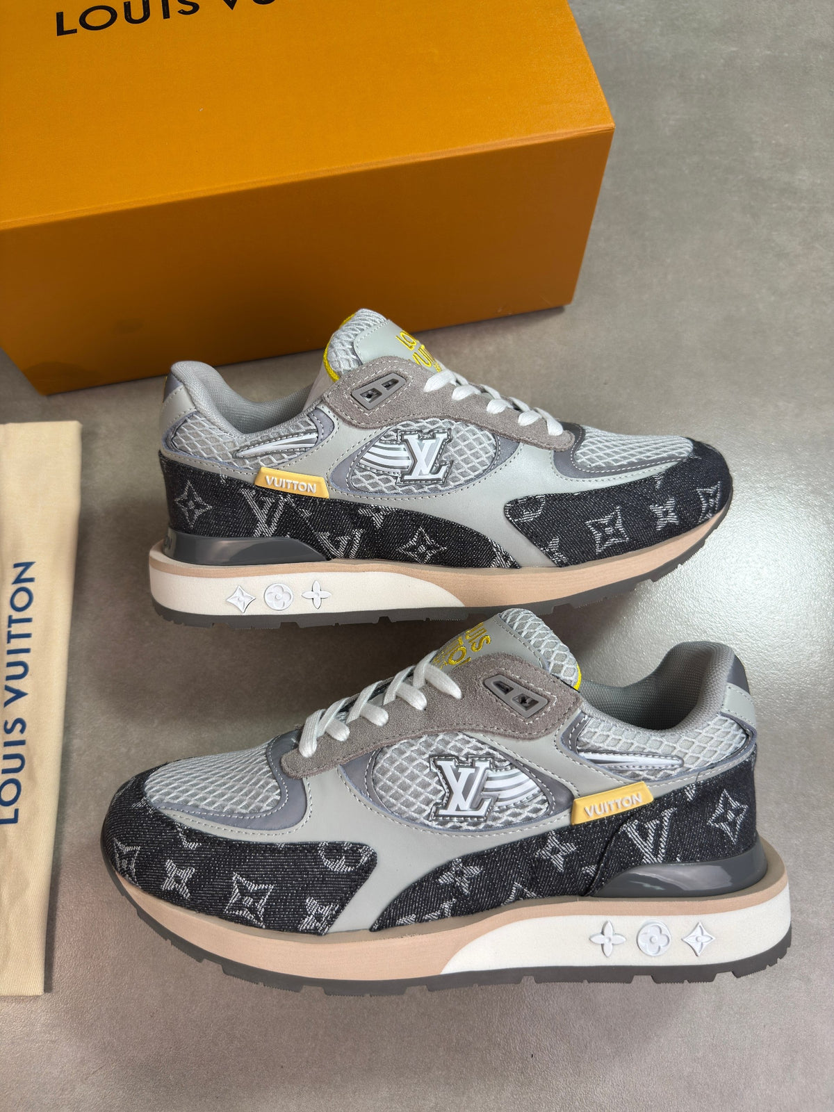 Pair of grey Louis Vuitton trainers with black monogram pattern, front view