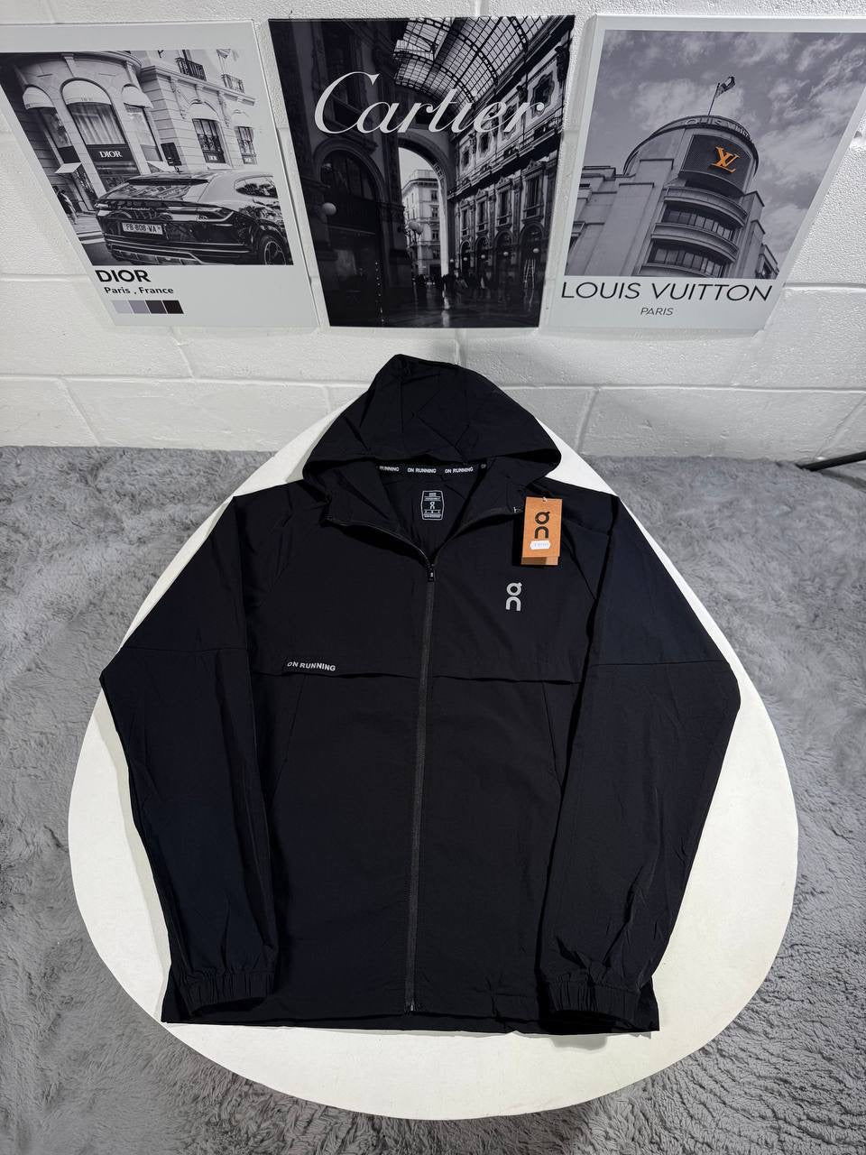 Hooded zip tracksuit jacket in black with logo patch and orange tag