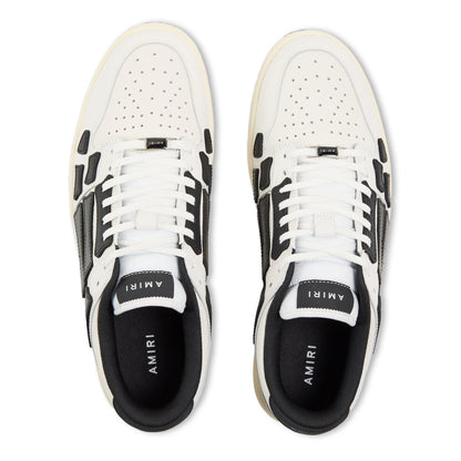 White low trainers with black side stripes and AMIRI logo on tongue