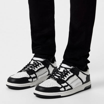 Low trainers in black and white worn with dark pants