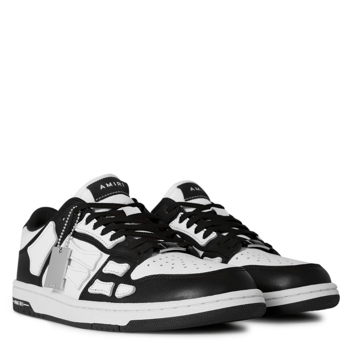 Pair of black-and-white low trainers, front view with lace-up design