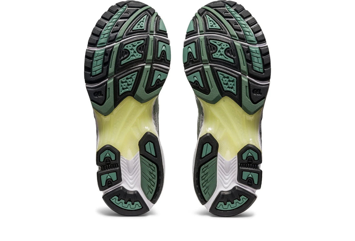 Gel Kayano 14 outsole view with textured tread, dark rubber sections, and green markings