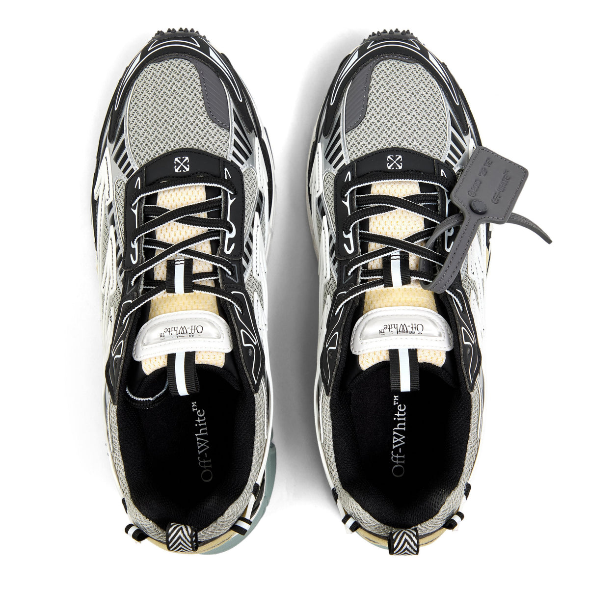Black and off-white retro sneakers with mesh upper, lace-up front, and gray pull tab.