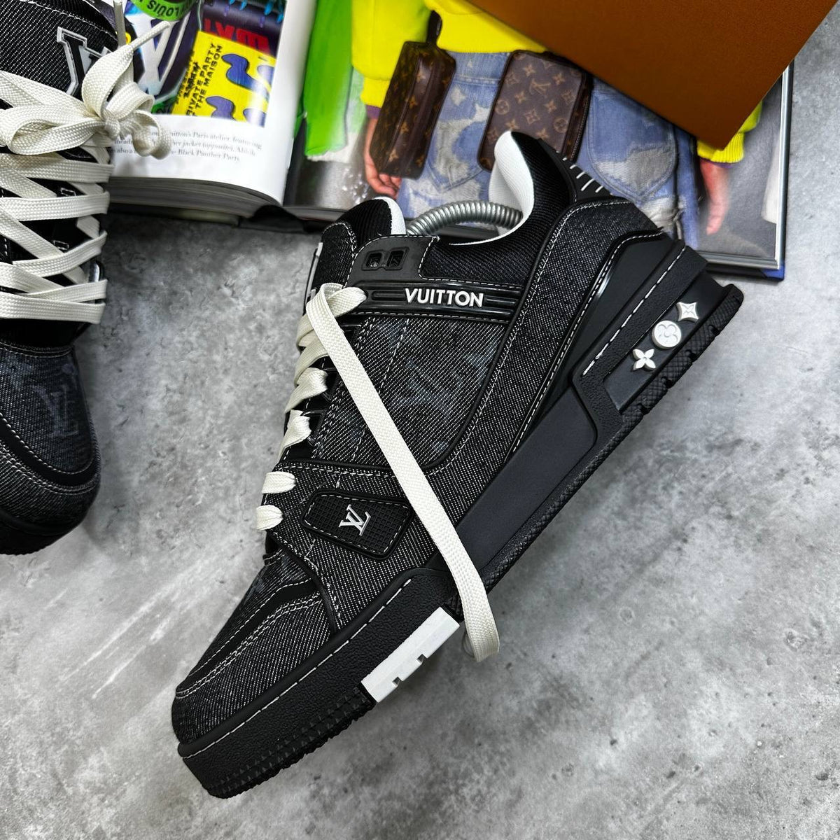 Black LV trainers with monogram panels, white laces, and chunky rubber sole.