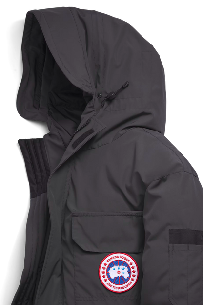 Expedition Parka Granite Grey, close-up of hood and front logo patch with pockets
