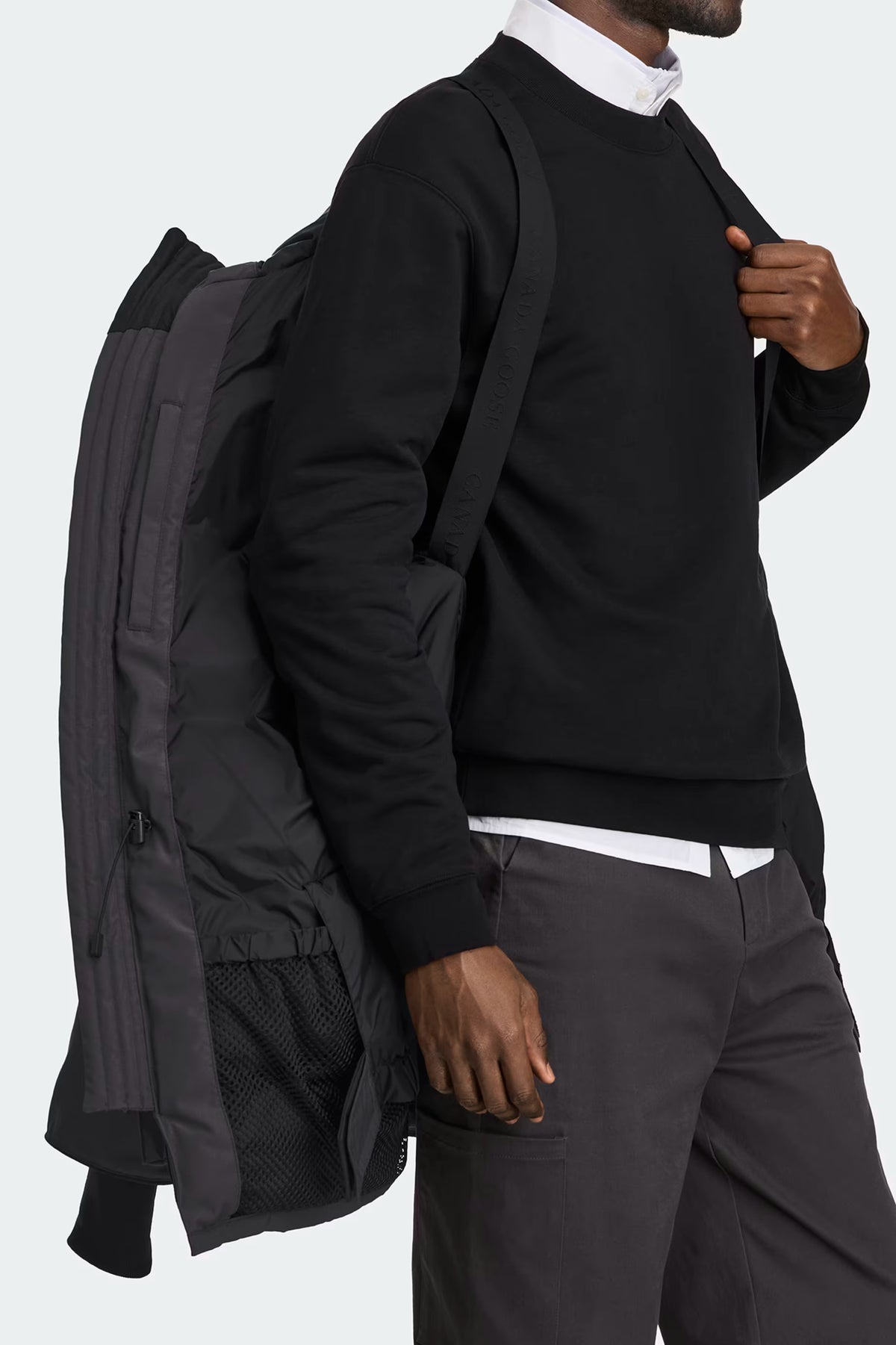 Expedition Parka Black, angled front view with side pockets and storm flap