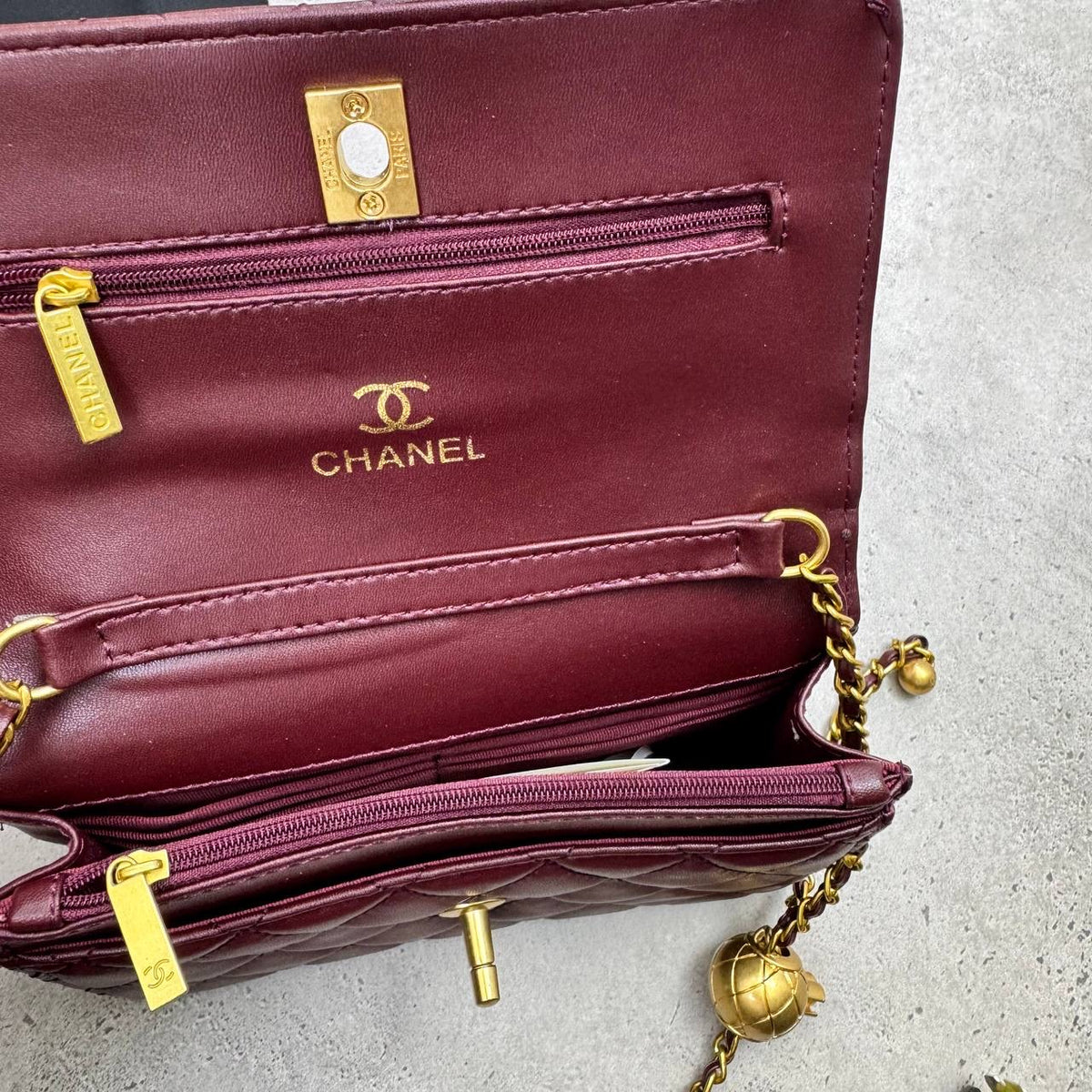 Burgundy quilted CC flap bag with gold-tone chain and turn-lock clasp