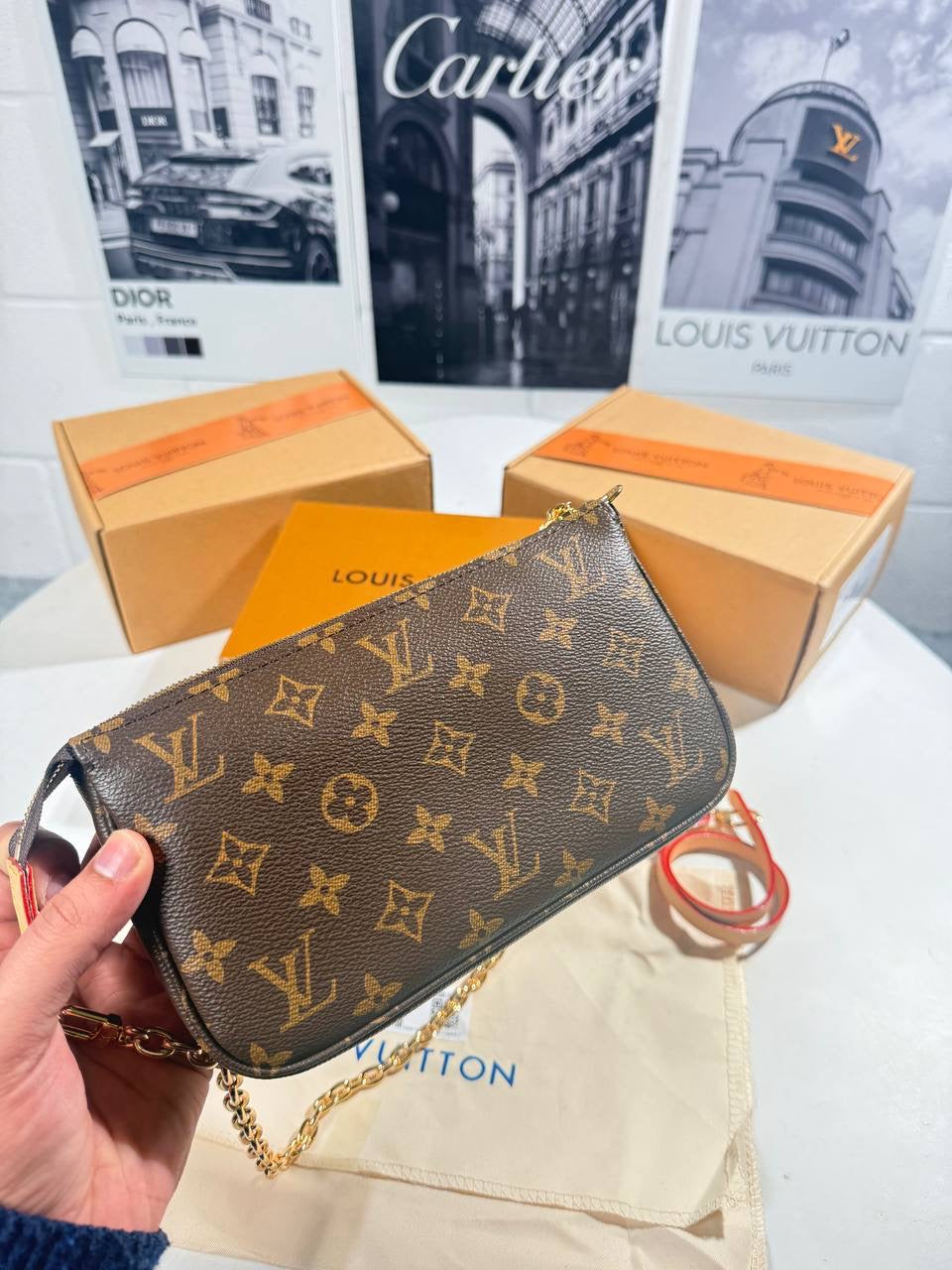 LV monogram pochette bag with gold chain strap and front flap clasp
