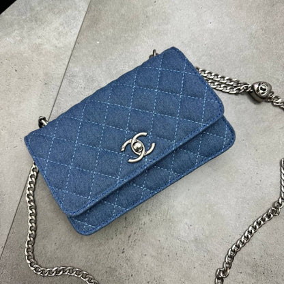 Blue quilted denim flap bag, front logo clasp and silver chain strap