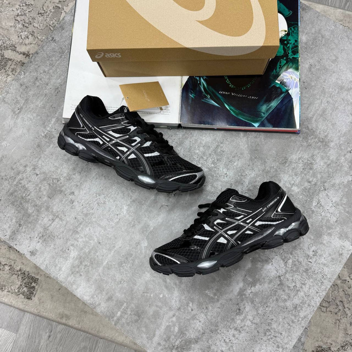 ASICS running shoes in black with silver stripe-style side design and dark outsole