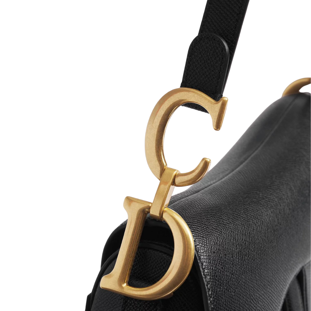 Close-up: black strap and gold-tone D hardware on CD Saddle Bag