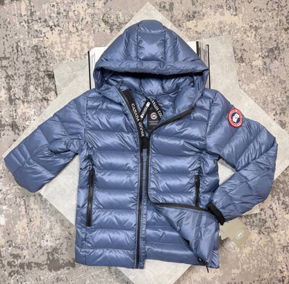 Blue hooded puffer jacket with full-zip front, long sleeves, and red sleeve patch