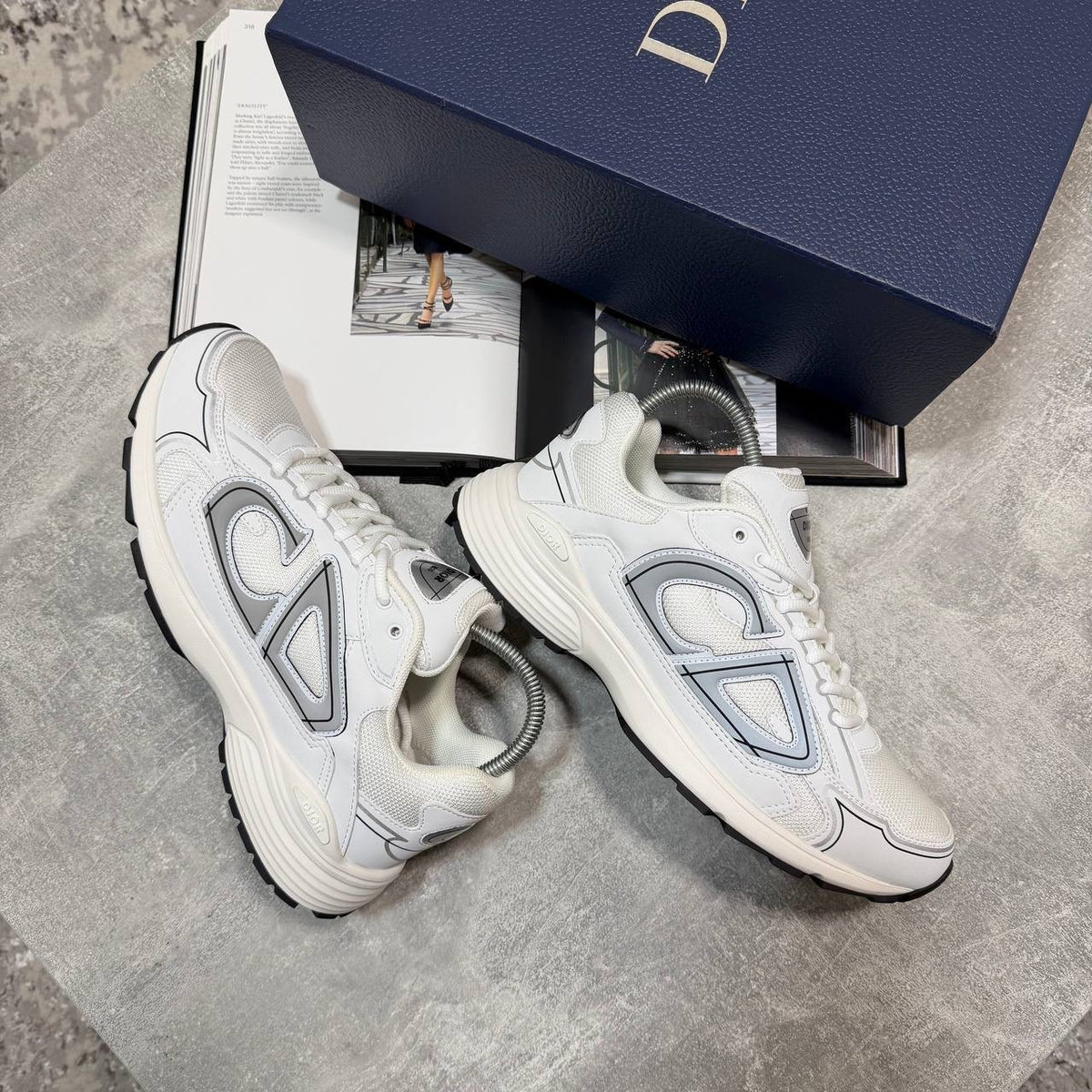 White lace-up stealth sneakers with gray and light-blue side panels and chunky tread sole