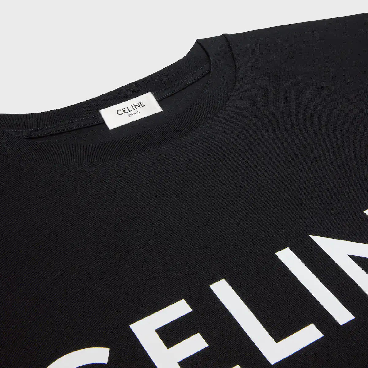 Black loose T-shirt neckline with brand tag and white CELINE lettering detail