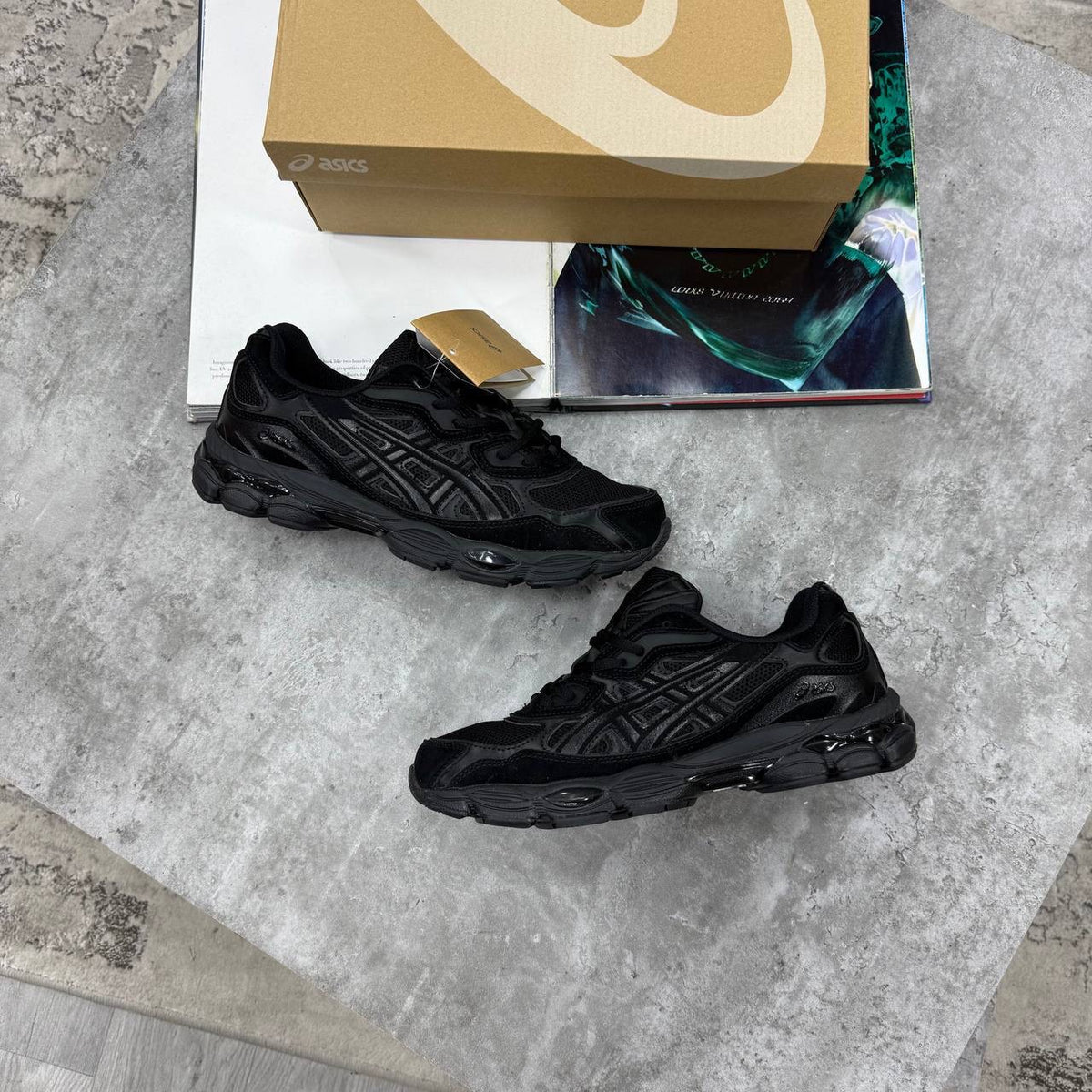 ASICS running shoes in solid black with textured side paneling and dark sole