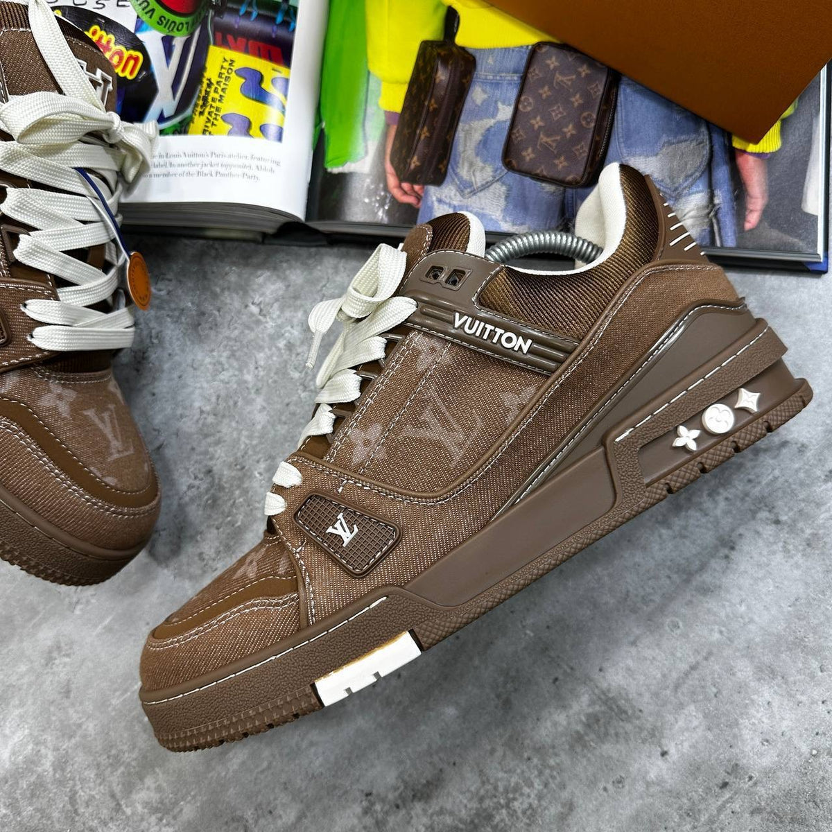 Brown LV trainers with monogram panels, white laces, and chunky rubber sole.