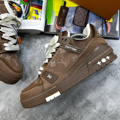 Brown LV trainers with monogram panels, white laces, and chunky rubber sole.