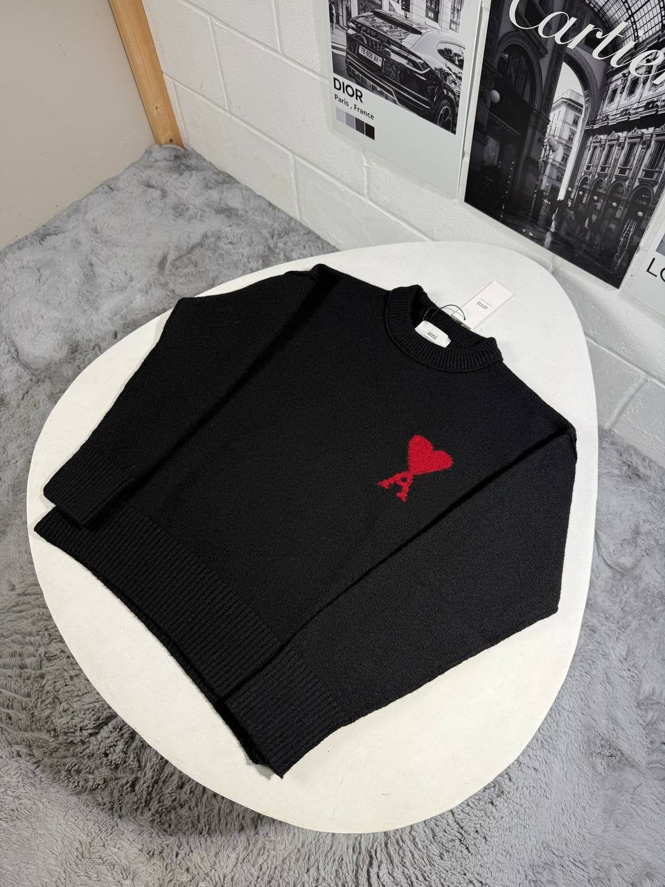 Black crewneck knit jumper with ribbed cuffs and hem, with a red heart graphic