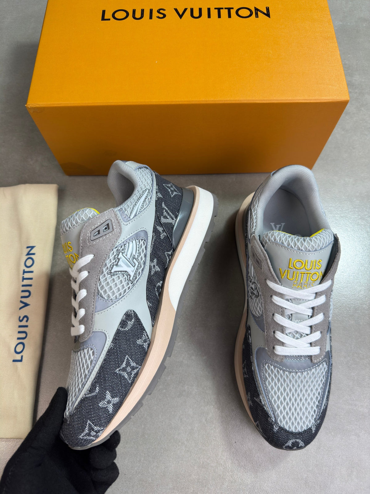 Grey Louis Vuitton trainers, front side angle with white laces and rubber sole