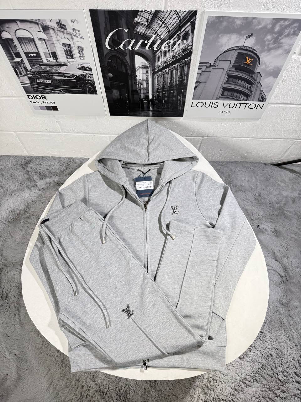 Light grey tracksuit jacket with hood drawstrings, front zip, and LV logo on chest