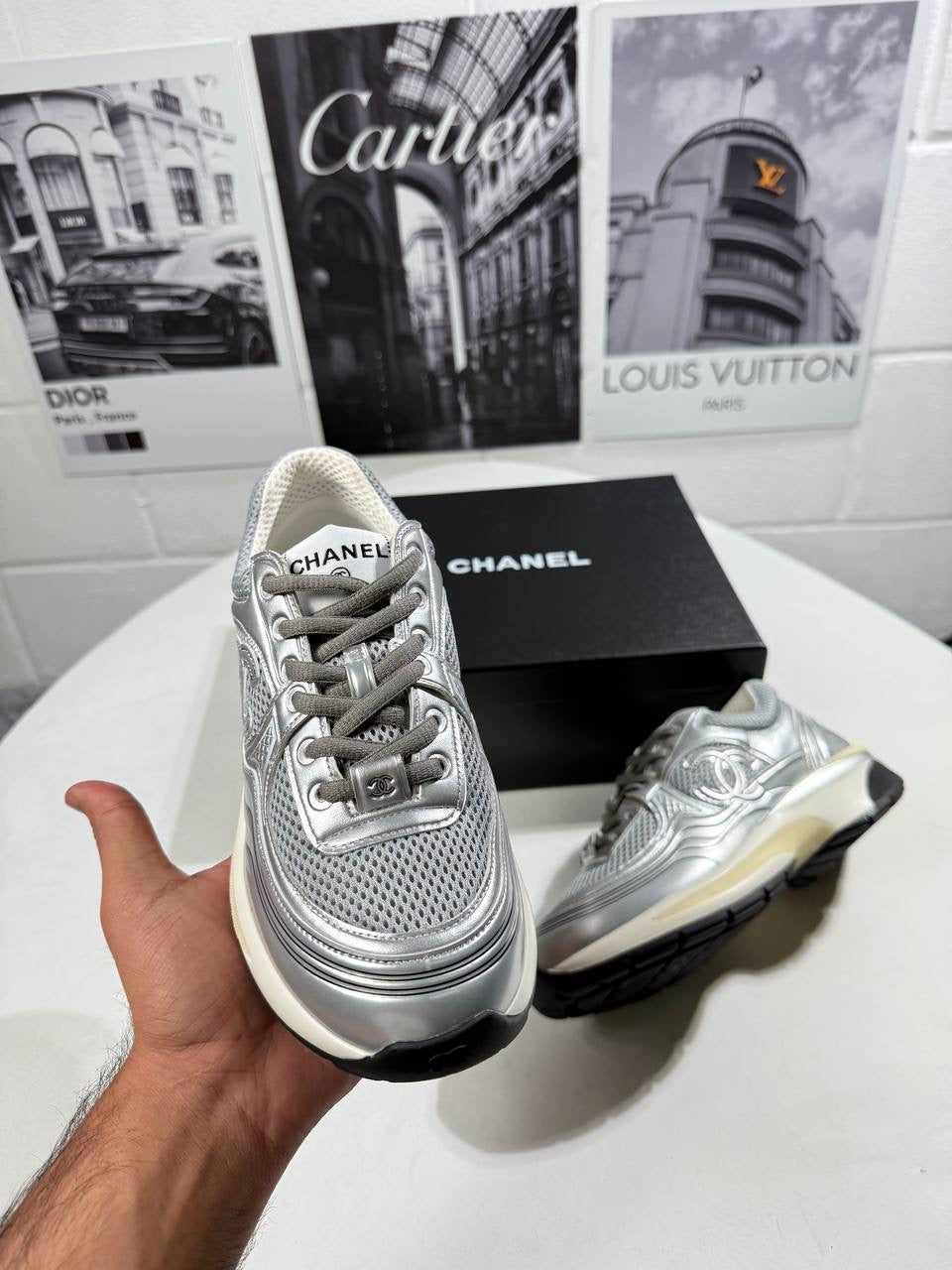 Silver lace-up trainers with embossed side pattern, black trim and cream edge sole