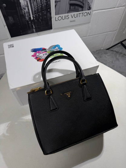 Black LV Alma BB-style tote bag with top handles and gold-tone hardware