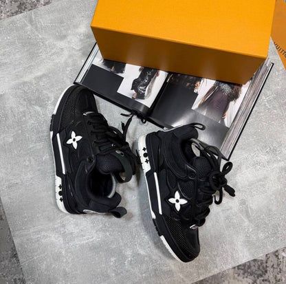 Black skate sneakers with white logo flower emblems, black laces, thick sole