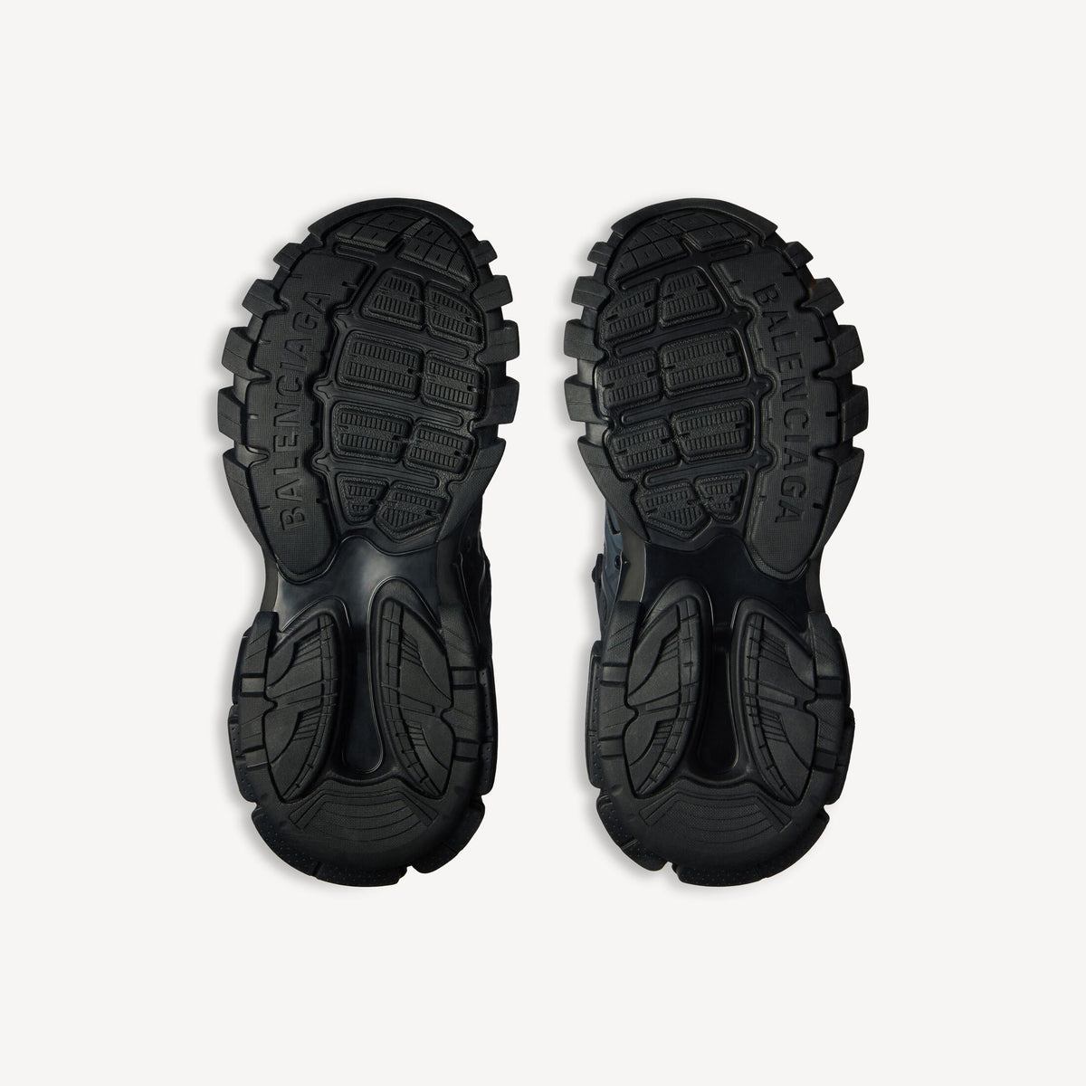 Men's black track sneaker, outsole view with deep traction tread