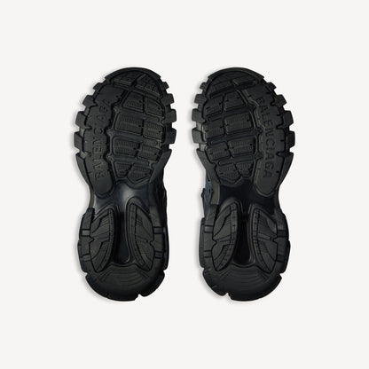 Men's black track sneaker, outsole view with deep traction tread