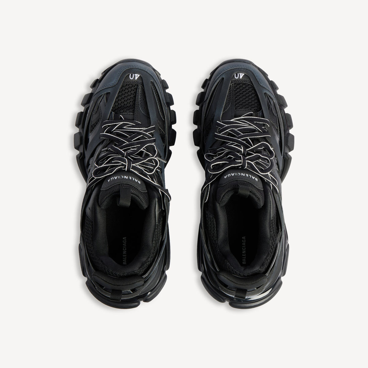Men's black track sneaker, top view showing laces, mesh lining, and logo patch