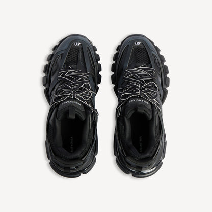 Men's black track sneaker, top view showing laces, mesh lining, and logo patch
