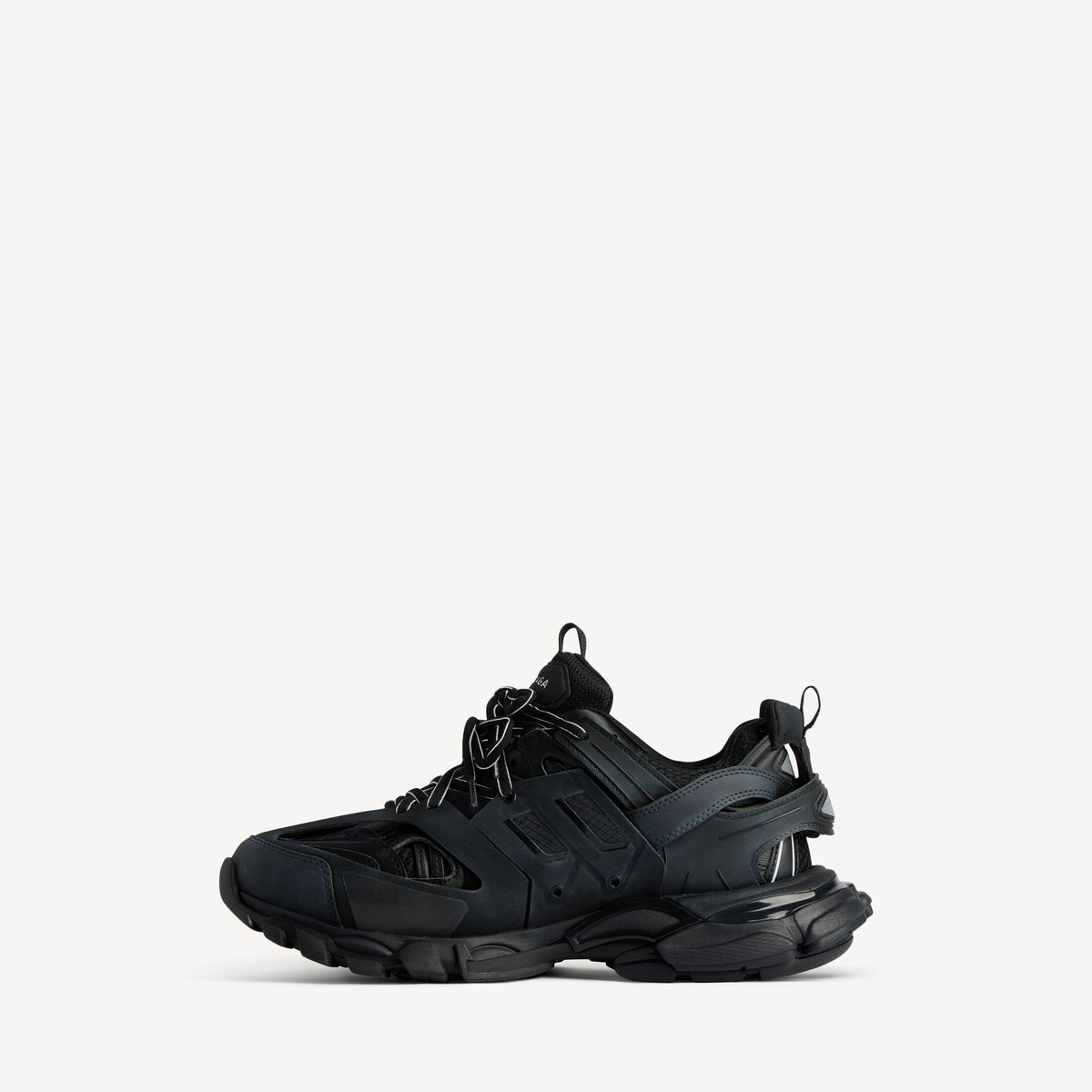 Men's black track sneaker, angled side view with strap details and laces