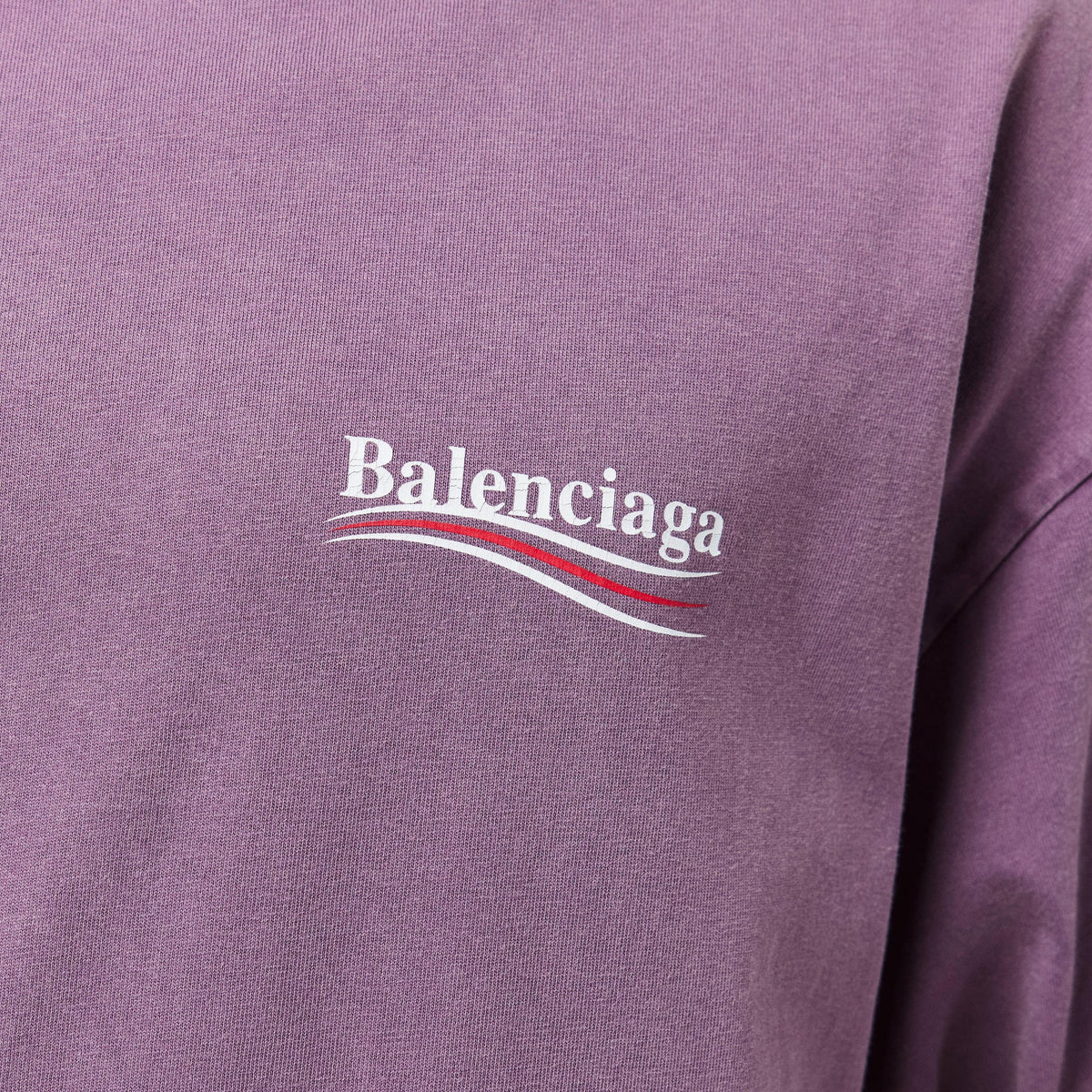 Close-up of Balenciaga logo on lilac T-shirt with multicolor line accents