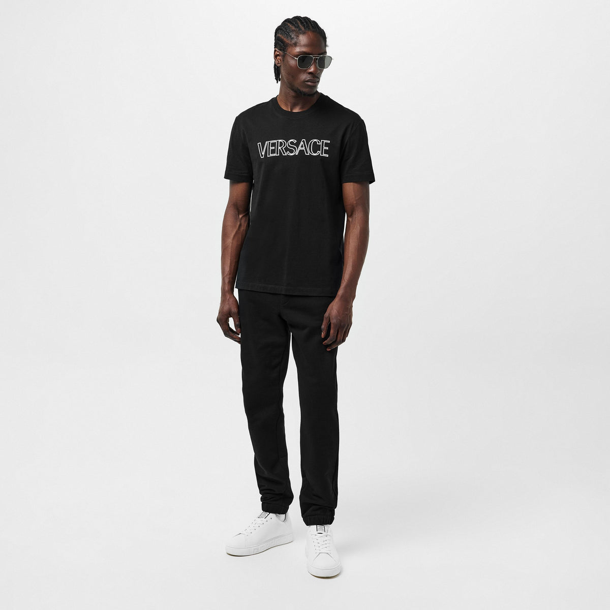 Versace black T-shirt with white chest logo, full-body view
