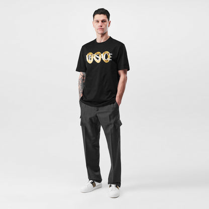 Black crewneck T-shirt featuring a gold Versace ring graphic on the front