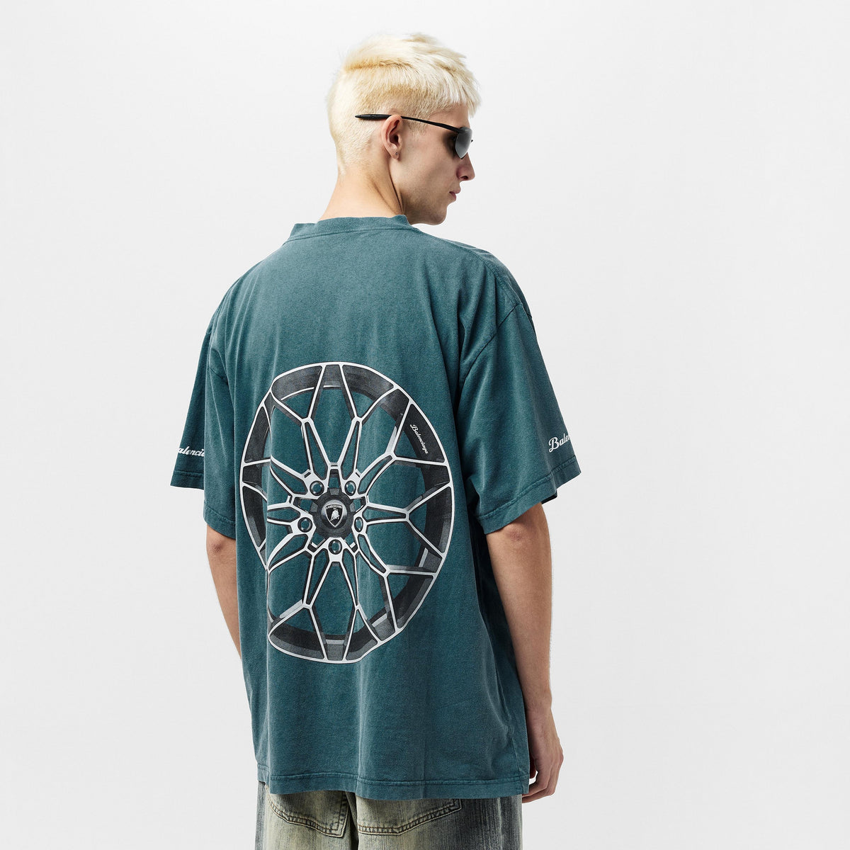 Petrol blue oversized T-shirt with rear wheel graphic; small side prints near hem