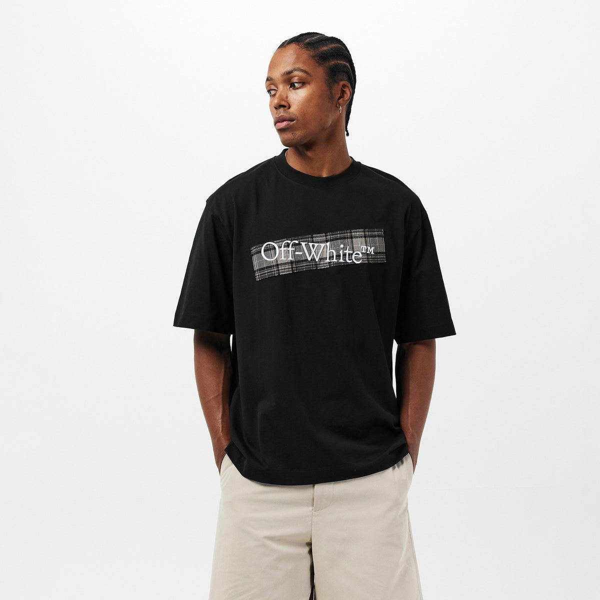 Black men’s Off-White T-shirt with chest logo, worn with light shorts